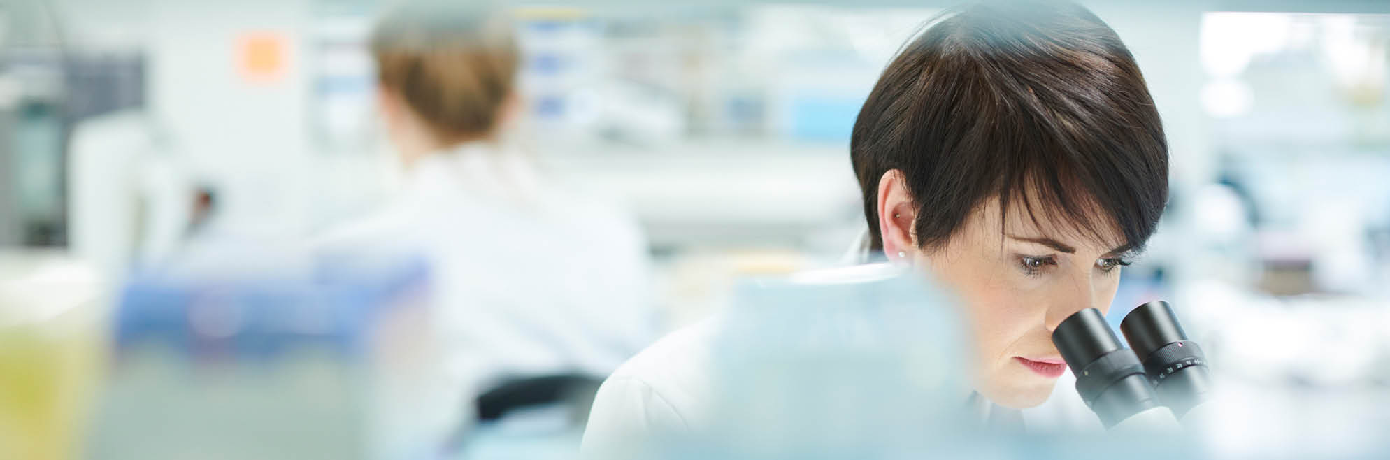 female scientist in a busy research lab